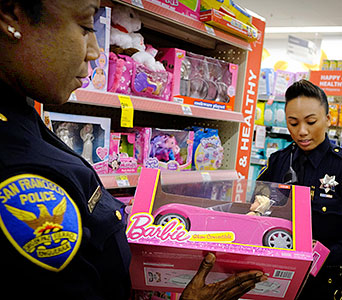 SFPD Female Officer holding pink Barbie car