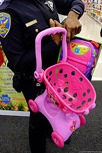 SFPD Officer holding pink shopping cart