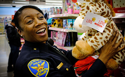 SFPD Female Officer holding stuffed animal toy