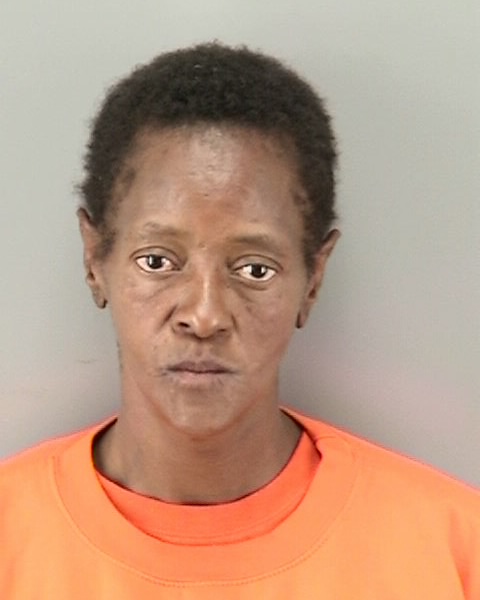 Booking photo of black female, Jacqueline Miller in orange shirt.
