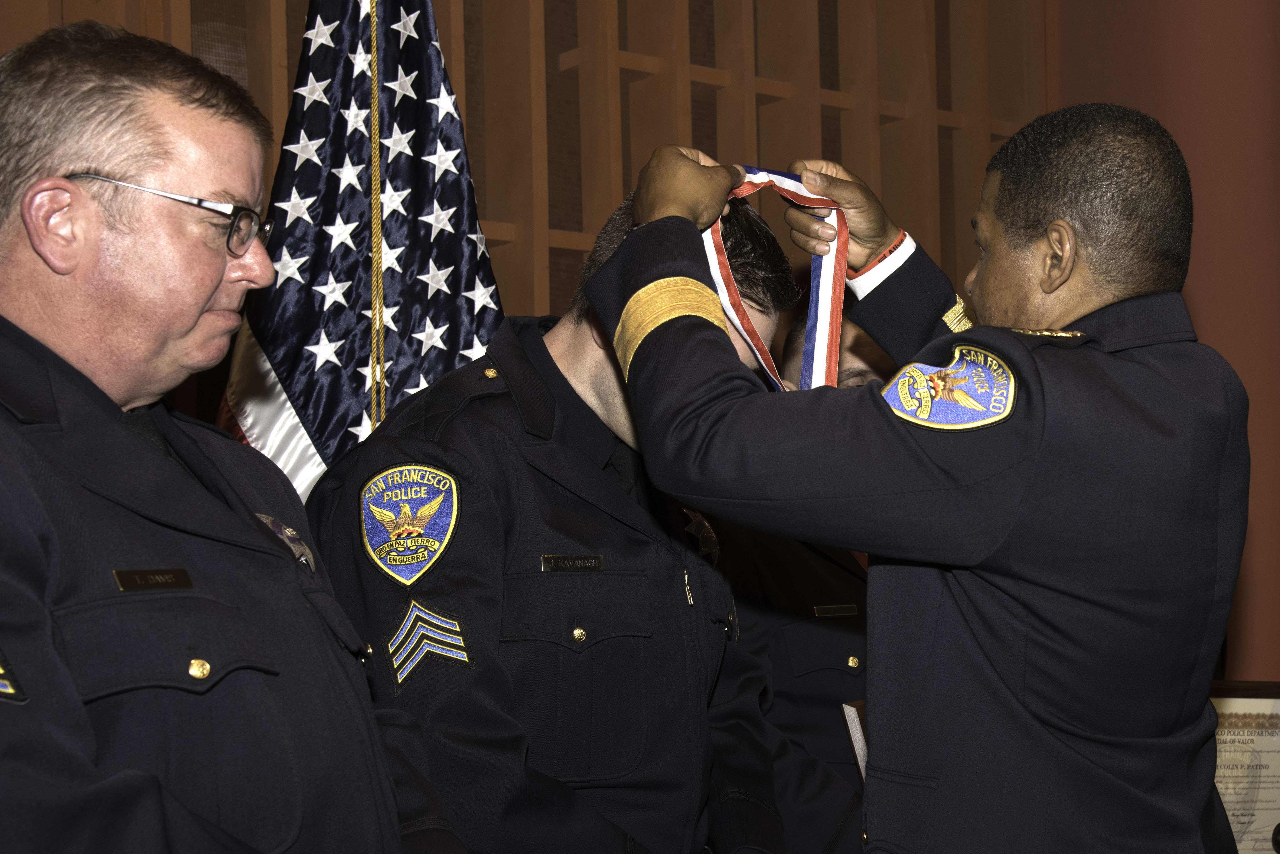 Chief putting ribbon on Officer