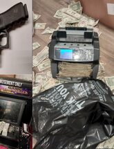 Image of firearm, gambling machines, and U.S. currency seized from illegal gambling den