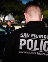 Image of officer standing at scene with blurred background