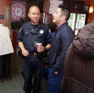 Image of police officer speaking with community members