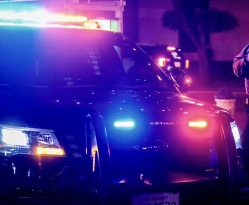 Image of patrol vehicle with emergency lights activated.